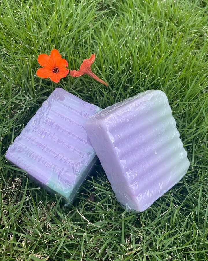 Ribbed lavender and sage soap bars on grass